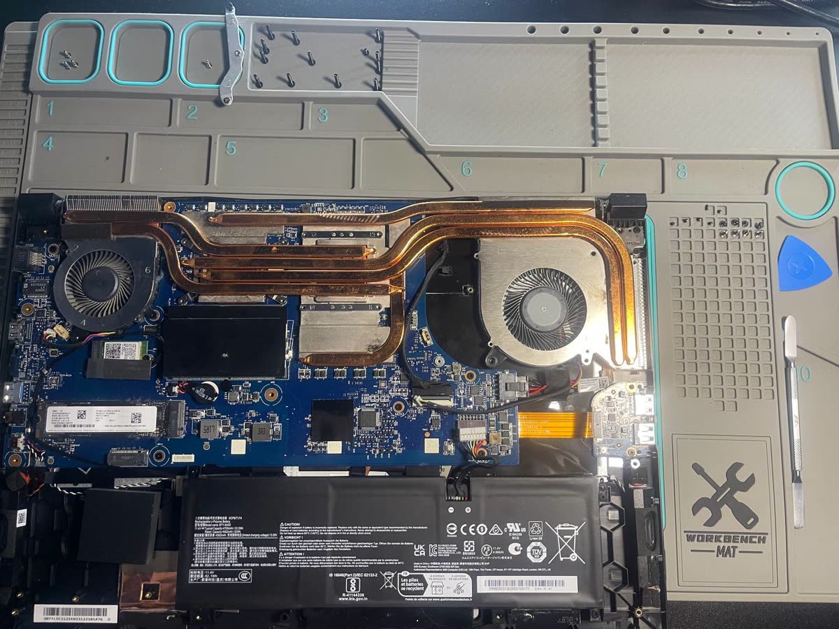 Szétszerelt gamer laptop alaplapja, két ventilátorral és négy rézcsöves hűtőrendszerrel